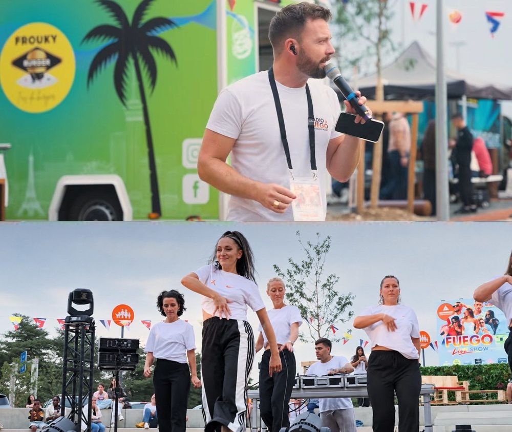 Animateur au micro et danseuses sur la scène du Fuego Live Show